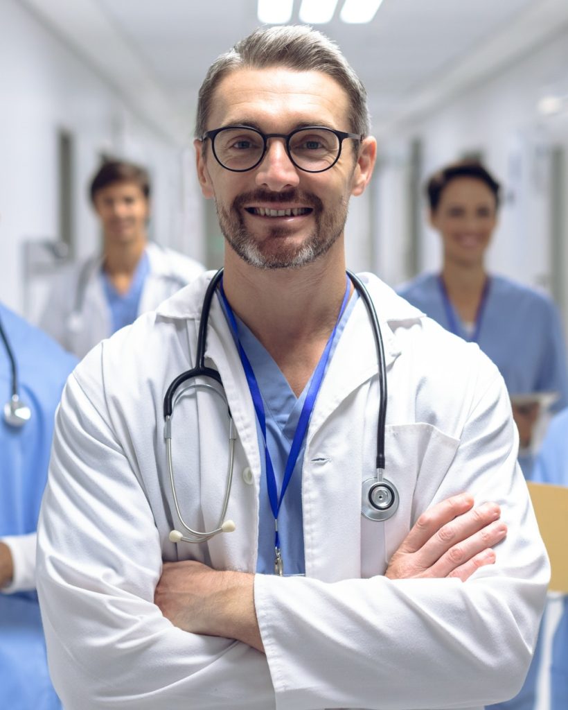 diverse-medical-team-of-doctors-looking-at-camera-while-holding-clipboard-and-medical-files